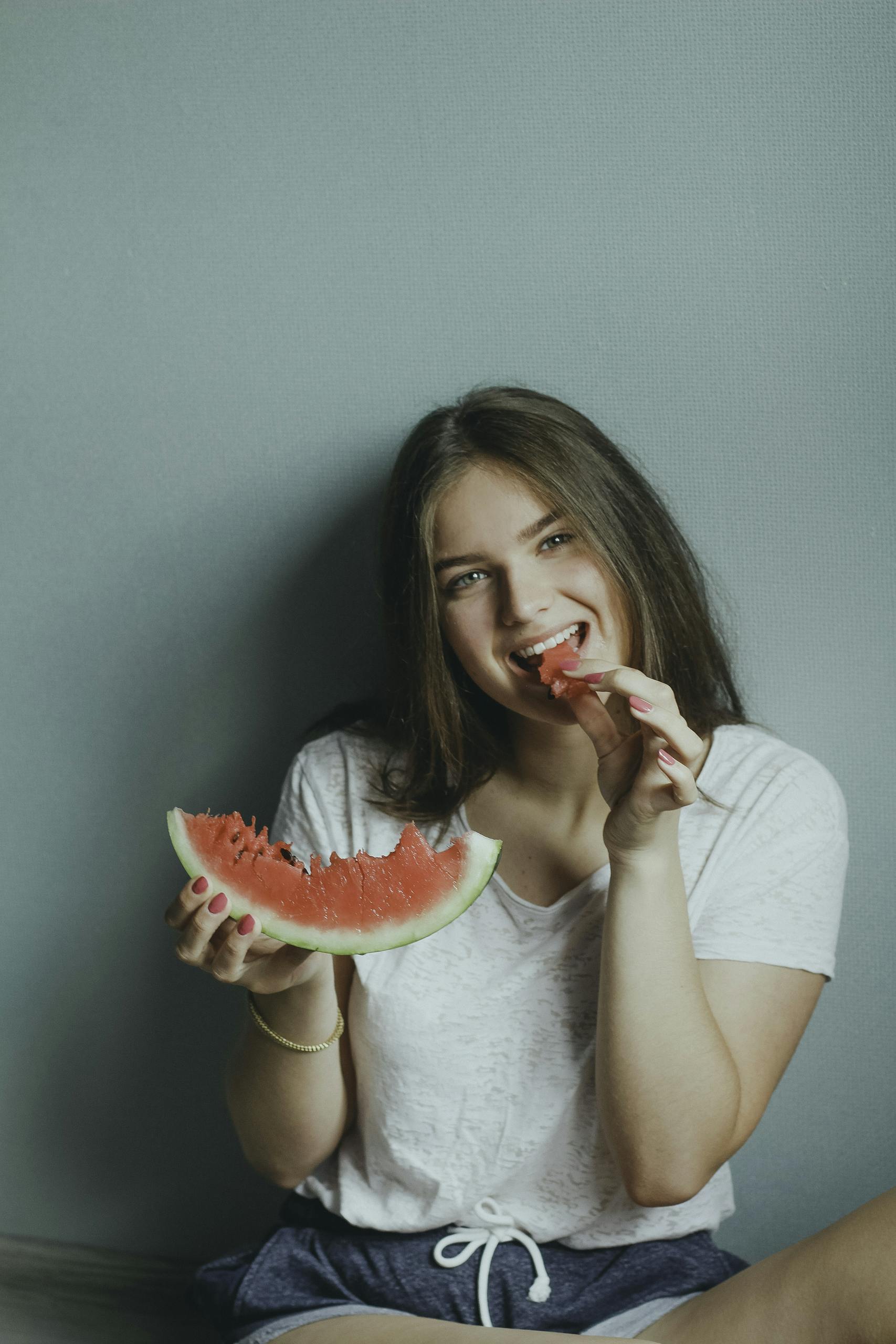 Woman Wearing White Shirt Eating Watermelon
