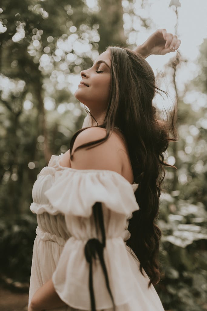 Young Woman in a Dress Posing in a Forest